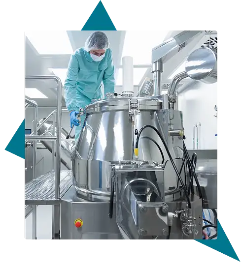 A person in protective clothing inspects a large stainless steel industrial tank in a clean, modern facility. Traffic Consultants, Inc. (TCI)